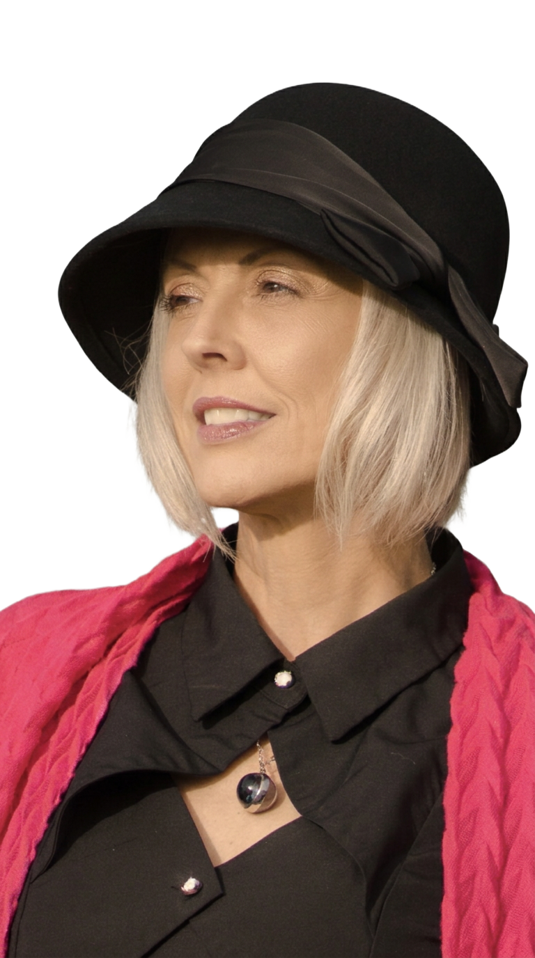 Tori wearing her black hat and hot-pink wrap